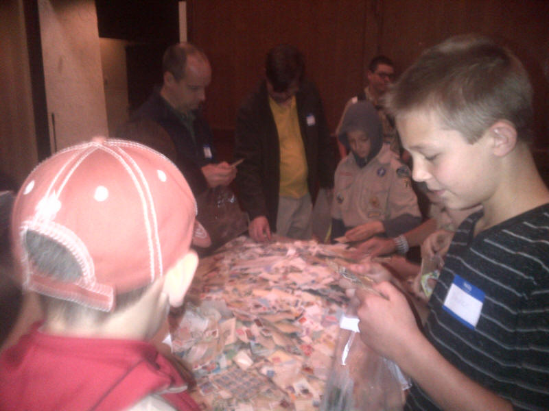 Young collectors look for free stamps at the PIPEX 2013 Youth Activities table